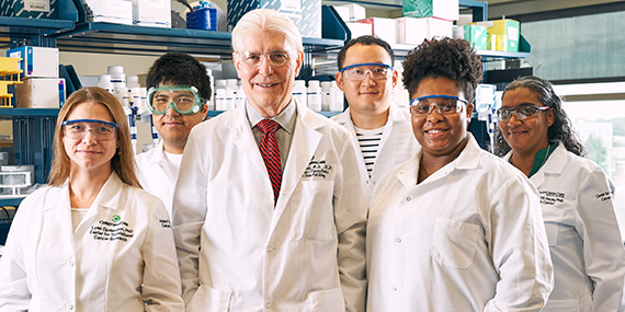 Dr. Bruce Boman stands with his team who discovered a second key pathway in colon cancer stem cell growth