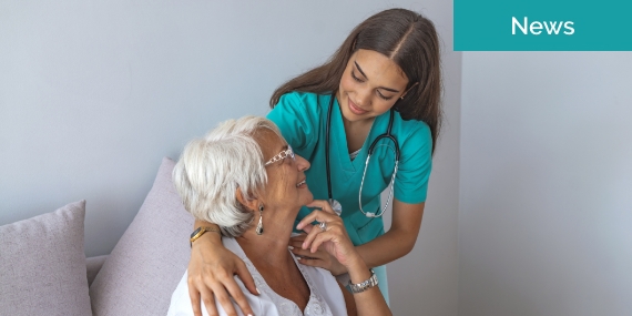 Nurse with hands on shoulders of patient