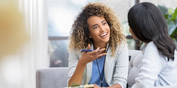 Therapist talks with young woman