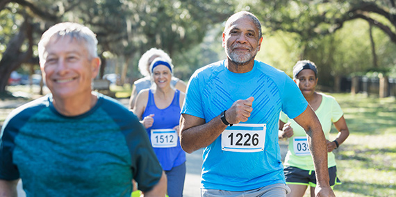 A group of seniors running in a marathon