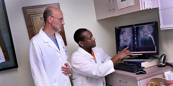 Two doctors examining an X-ray of a hip