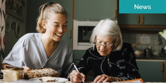 Nurse sitting next to elderly woman