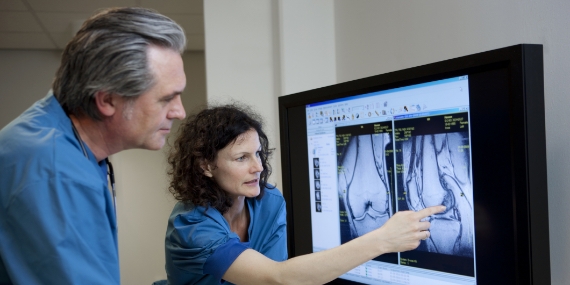 Doctors looking at MR image of knee