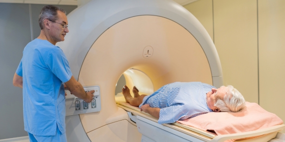 Radiologist with a patient at CT scan