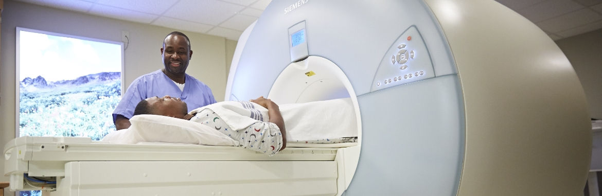 Doctor looking at scan while patient is in testing room