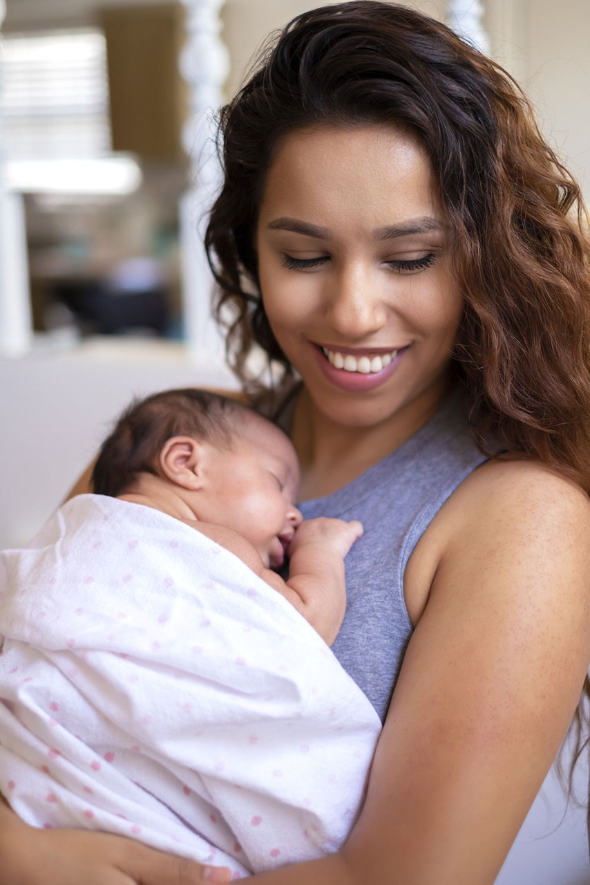 Mother holding sleeping child in arms