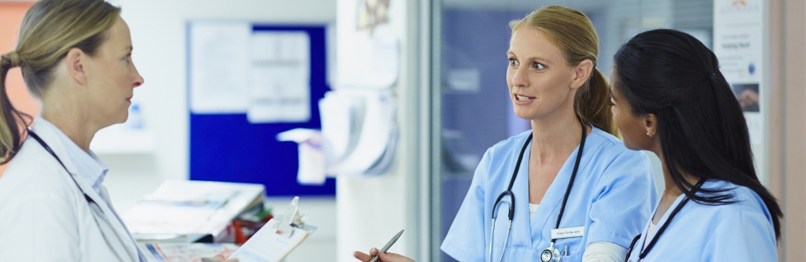 Doctor discussing with nurses in hospital