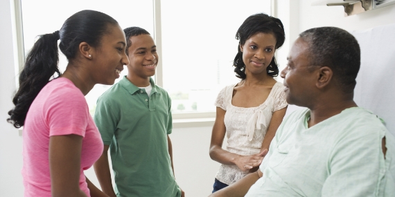 Family with father in hospital room
