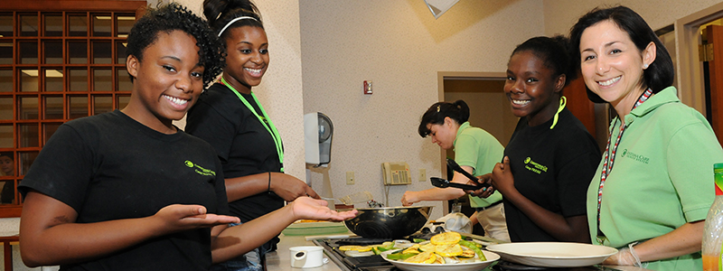 Young members of the community preparing meals