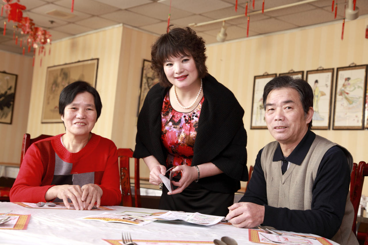 group of people standing and sitting around a table