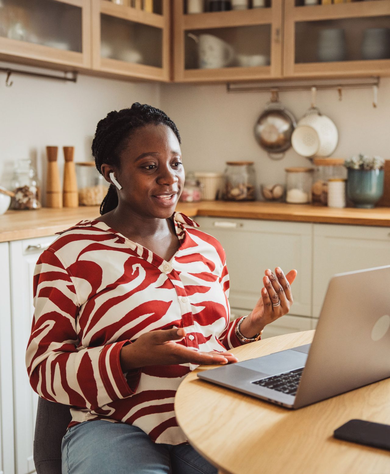 Woman on laptop speaking to doctor