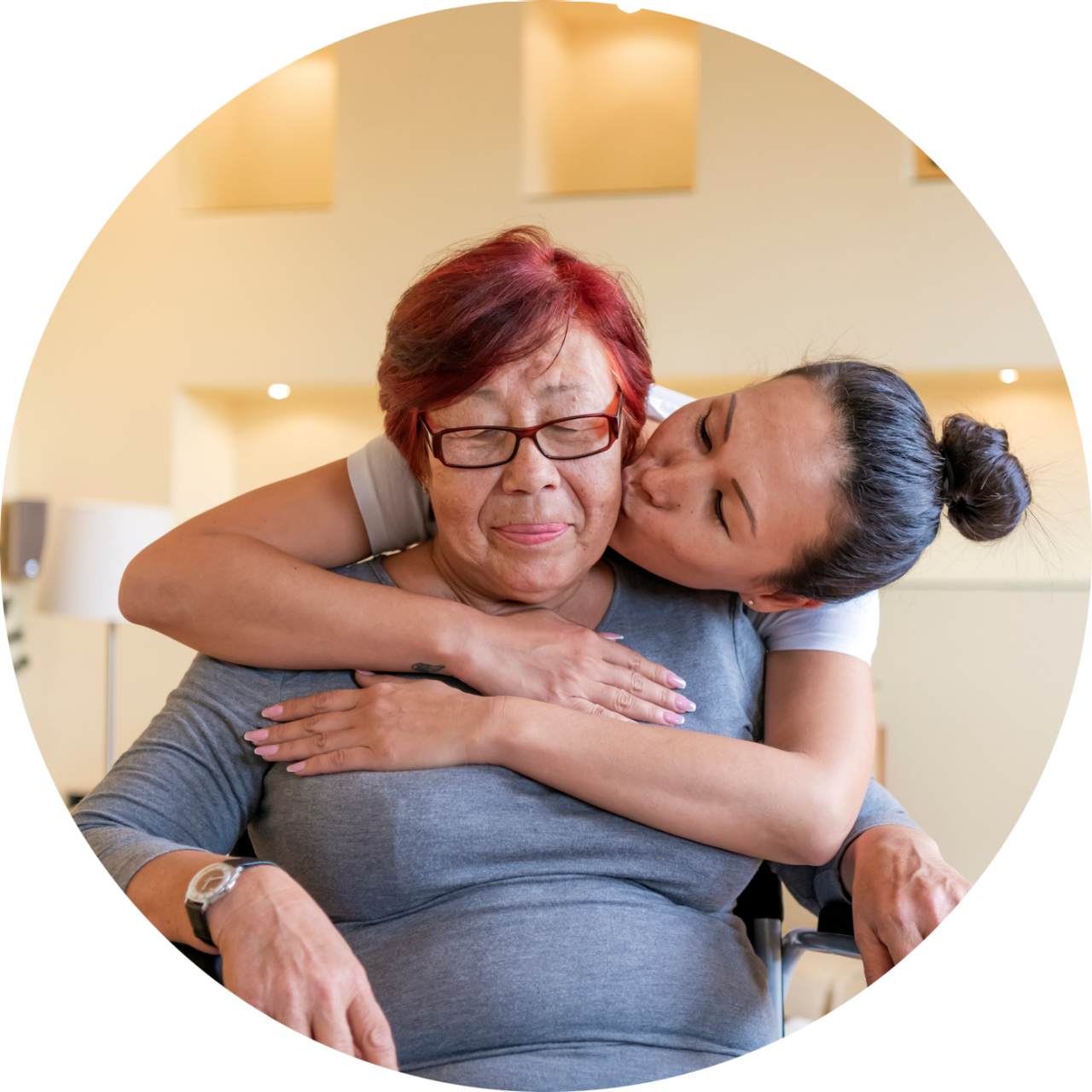 Senior Woman in a Wheelchair Receiving Support from her Daughter.