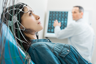 Woman monitored using medical testing equipment 