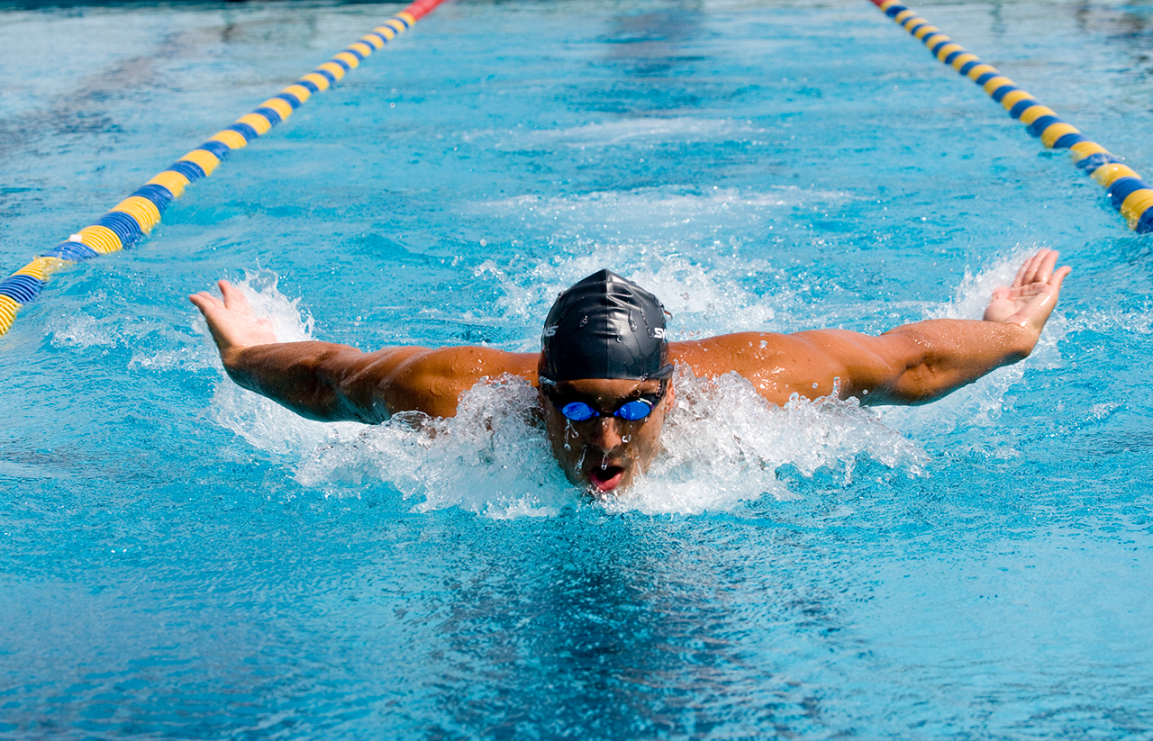 A man competing in a breast stroke swimming race