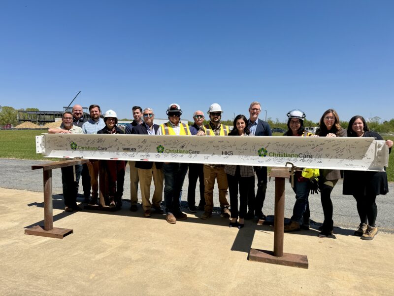 Members of the Junior Board, ChristianaCare leaders and caregivers signed the final steel beam before it was lifted into place at the Middletown campus