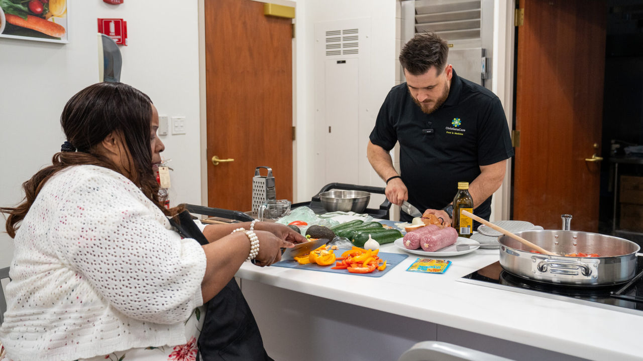 Arlene Daniels and Eric Lautz preparting a meal