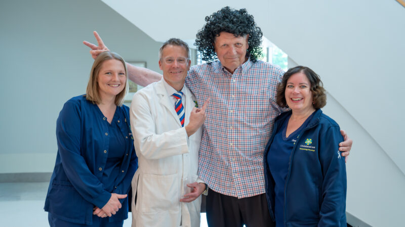 Bill Osborne with a Rock Star wig with his care team around him