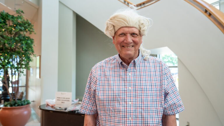 Portrait of Bill Osborne wearing a George Washington wig