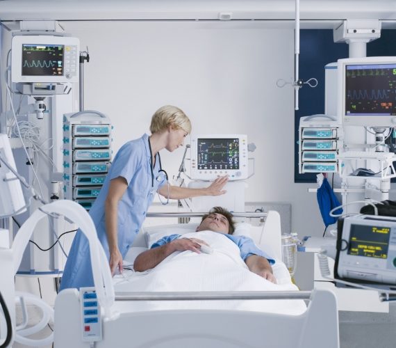 Nurse tending patient in intensive care
