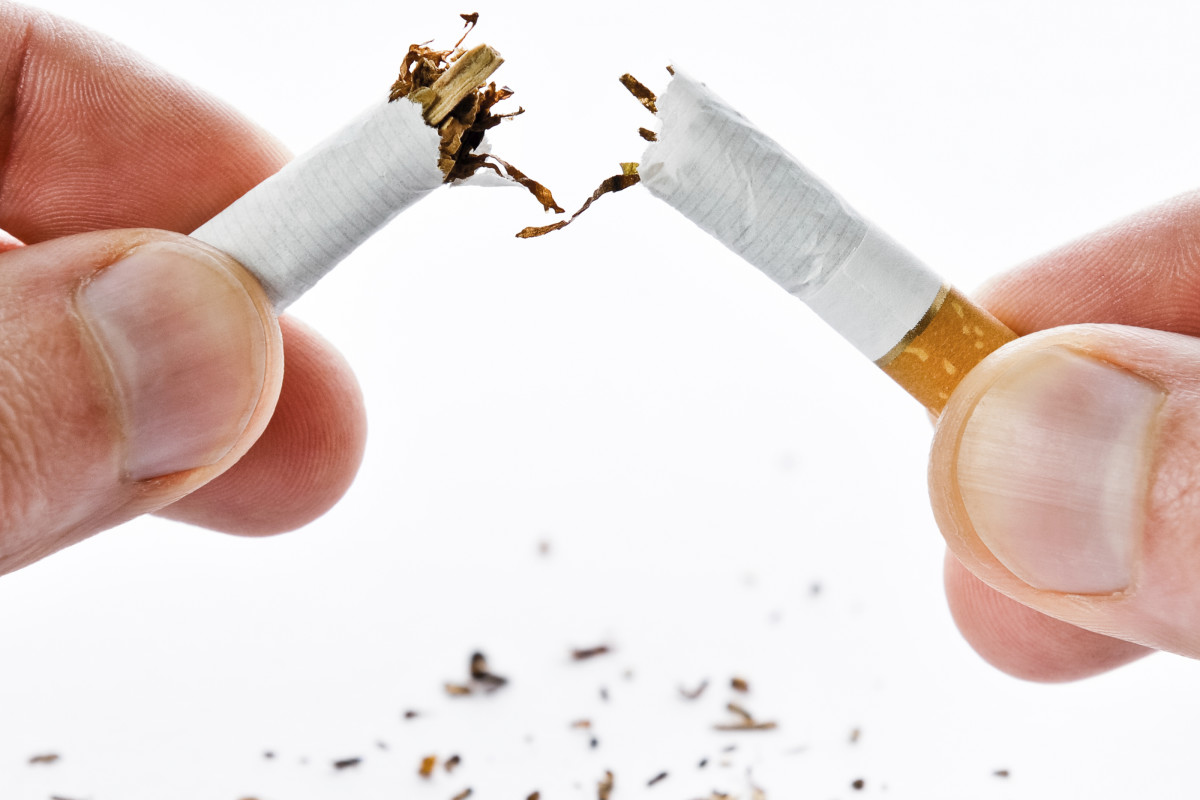 Cigarette being broken in half