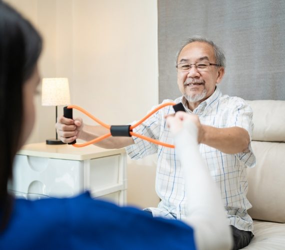elderly man doing physiotherapist with therapist nurse